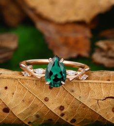 a green ring sitting on top of a leaf