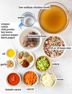 the ingredients to make chicken broth laid out on a white counter top, including carrots, onions, celery, onion, and seasonings