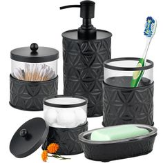 black bathroom accessories including soap dispenser, toothbrush holder and tissue dispenser