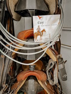 an assortment of old saddles and hats