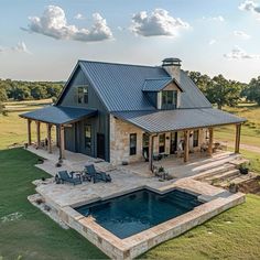 a house with a pool in the middle of it and a covered patio next to it