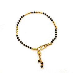 This exquisite 22kt gold mangalsutra hand bracelet is a perfect blend of traditional significance and contemporary elegance. The bracelet features gorgeous black beads interspersed with gleaming gold accents, creating a striking contrast that enhances its beauty. Crafted from high-quality 22kt gold, it radiates a luxurious glow, symbolizing both purity and prosperity. Lightweight and comfortable, this bracelet is designed for women who appreciate both tradition and style. Ideal for gifting, it s Personalized Silver Jewelry, Gold Pendent, Couples Quotes, Couples Quotes Love, Gold Jewelry Simple Necklace, Gold Mangalsutra, Light Weight Jewelry, Gold Armband, Hand Bracelet