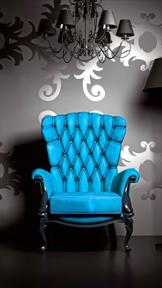 a blue chair sitting in front of a lamp