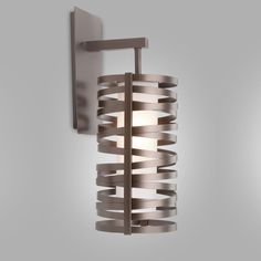 a wall light that is mounted to the side of a wall with metal strips on it