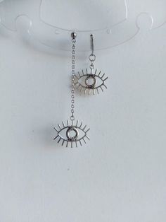 The earrings are decorated with silver pendants in the shape of brass eyes. The earrings are fastened with stainless steel hoops. Earring length - 7.0 cm (2.8 inches) Earrings are packed in a gift box Stainless steel silver chain with pendants in the shape of brass eyes. Chain length-  45.0 cm (18.0 inches) The necklace is packed in a gift box RECOMMENDATIONS FOR CARE: Do not wet, do not drop, and store in a dark box! - Remove jewelry before exercising, swimming, showering and sleeping. - Avoid Anime Earrings, Grunge Jewelry, Y2k Goth, Gothic Earrings, Eye Earrings, Goth Grunge, Silver Pendants, Grunge Fashion, Handmade Shop