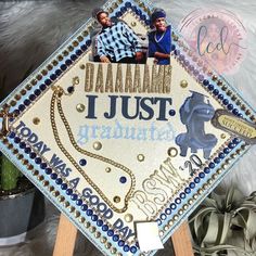 a decorated graduation cap sitting on top of a wooden stand