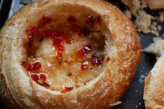 some type of bread with jelly in it on a tray next to other food items