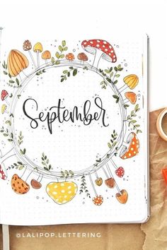 an open notebook with the word september written in it and various items surrounding it on top of a piece of paper