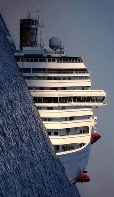 a large cruise ship in the ocean near another boat