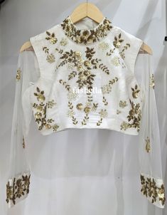 Beautiful Hand Embroidered white and gold blouse! This beautiful blouse can be paired with any sari or lehenga! MEAUREMENTS & CUSTOMIZATIONS This blouse can be made in ANY COLOR. Please drop us a convo to choose your preferred color.  This blouse can be purchased in your standard sizing and pattern. Please choose your Chest Size (measured in inches) from the drop-down box. For custom sizing please include the below measurements in the the notes to whenever you placed the order.  * Chest size: * Waist size: * Blouse Length: * Bicep: * Arm-hole: * Sleeve Length: * Front Neck Depth: * Back-Neck Depth:  SHIPPING DETAILS  Please leave your contact number in notes section while placing the order OR message us later. The shipping companies need your contact number incase they need to contact you Blouse Piece With Intricate Embroidery For Celebration, White Blouse With Floral Embroidery For Wedding, White Floral Embroidery Blouse For Wedding, White Floral Embroidered Blouse For Wedding, Traditional Embroidered Top With Drape For Wedding, Traditional Embroidered Top With Traditional Drape For Wedding, Fitted Saree With Gold Embroidery For Diwali, Transitional Season Fitted White Choli, Transitional Season White Fitted Choli