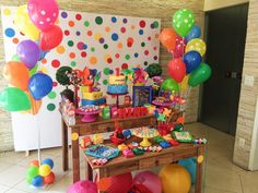 a birthday party with balloons, cake and decorations