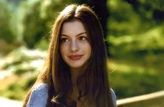 a woman with long brown hair is posing for the camera