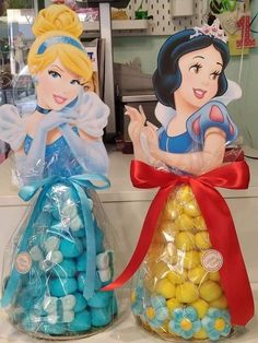 two plastic bags filled with candies in the shape of snow white and princesses