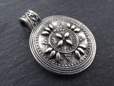 1 lovely large Matte Antique Silver Plated round artisan tribal style boho pendant with bail. Quantity: 1 pc Shape: Round Size: Diameter = 28 mm round Height: 37 mm with top mounted bail loop Color: Matte Antique Silver Plated All my findings are lead free, nickle free/nickle safe. Bohemian Jewelry With Large Round Pendant, Bohemian Nickel-free Round Disc Jewelry, Bohemian Jewelry With Round Coin Pendant, Bohemian Jewelry With Coin Pendant, Handmade Bohemian Round Disc Jewelry, Bohemian Handmade Round Disc Jewelry, Handmade Bohemian Disc Jewelry, Antique Pendant, Boho Pendant