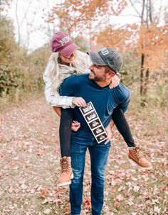 a man carrying a woman on his back in the woods