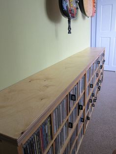 an entertainment center with several cd's on the shelves