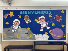 an image of children's artwork on the wall in school room with space theme