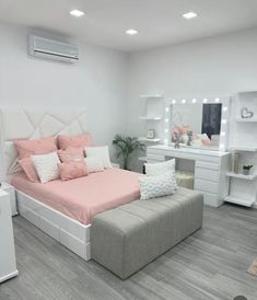 a bedroom with a bed, dresser and mirror in the corner on the wall next to it is an air conditioner