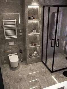 a bathroom with a toilet, shower and shelves on the wall next to each other