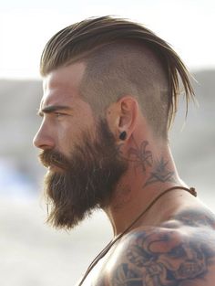 For a low-maintenance yet bold look, the Buzzed Undercut combines practicality with edge. This style is best for those with robust features and any eye color, fitting perfectly with a minimalist drip outfit or tattoo for an enhanced masculine look. Undercut Hair Men, Men’s Long Undercut, Undercut Mens Hair, Male Undercut Hairstyles, Viking Hairstyles Men Short Hair, Undercut Beard, Men Haircut Viking, Undercut For Men, Men’s Viking Hairstyles