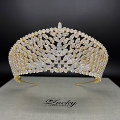 A breathtaking tiara designed in line with elegant royal crowns. Hundreds of perfectly cut high-quality Cubic Zirconia enhance the curvature of this piece. A single solitaire marquise zirconia completes the upper slanted row.  Available on www.ProBridalUSA.com *Handcrafted with highest quality Zirconia jewels and rhodium plated to prevent tarnish and scratch. *High Quality Teardrop, Marquise and Round CZ gems. *Measures 2.875 inches in center  *Ideal for Wedding, Bridal Hair, Anniversary, Quince Elegant High Crown Gold Crown, Regal Structured Crown Wedding Headpiece, Elegant Tall Crown For Party, Regal Wedding Headpiece With Structured Crown, Regal Structured Crown Headpiece For Wedding, Regal Tall Crown For Formal Occasions, Formal Tall Regal Crown, Elegant Tall Gold Crown, Royal Tall Crown For Wedding