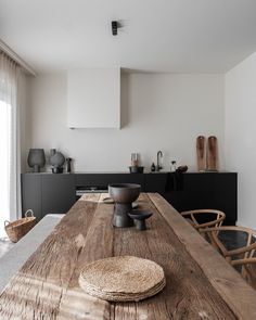 a wooden table sitting in the middle of a kitchen