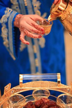 a close up of a person pouring something into a bowl with other items in front of them