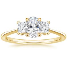 a yellow gold engagement ring with three stones