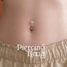 a close up of a woman's stomach with a piercing on it