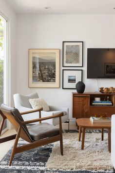 a living room filled with furniture and pictures on the wall