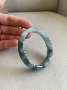 "🌈 Jade Bangle 53.0mm (2.09\"), Oval Shape, Green and Oil Green 🌷 Untreated Natural Jadeite/ Grade A Jade, Certified 🌷 Jade from Myanmar/ Burma 🌷 100% handmade carving 🌷 Shape : Oval 🌷 Inner diameter : 55.2 x 49.7 mm ----> fit for round shape 53.0mm / 2.09\" 🌷 Color : Green and Light Green 🌷 Free standard shipping from Hong Kong with tracking included 🌷 Take approximately 7-21 days to arrive worldwide ❤️ In Chinese Culture: Young people wear jade pendant will have a prosperous life, Classic Green Round Bangle, Elegant Oval Green Bangle, Elegant Green Oval Bangle, Green Gemstone Bracelets, Lavender Green, Jade Bangle, Fancy Jewellery, Jade Bracelet, Jade Jewelry