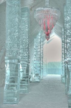 the inside of an ice hotel with stairs and chandeliers