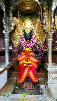 a statue in the middle of a room with many decorations on it and other items around it