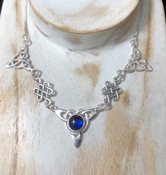 "I've fabricated a Victorian Bohemian style necklace with a center Celtic knot which features a center 10mm natural cabochon gemstone of your choosing, with two Trinity component pieces on either side, and two Celtic stenciling components to compliment the trinity knots. The sterling chain of 15 inches is soldered to each end making the approximate length of this piece just a bit over 18\" total. The chain will have a sturdy lobster claw. If you prefer a faceted gemstone, within a heavy 4 prong Spiritual Necklaces With Round Natural Stones, Spiritual Cabochon Necklaces, Spiritual Cabochon Necklace, Artisan Birthstone Necklace For Gifts, Artisan Birthstone Pendant Necklace, Silver Bohemian Birthstone Necklace, Spiritual Sterling Silver Necklace With Round Stone, Artisan Sterling Silver Necklace With Birthstone, Adjustable Cabochon Round Pendant Necklace