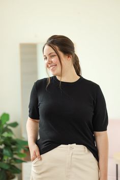 Our Lundy Top is such a great top to add to your wardrobe. This soft knit top is perfect for wearing alone or layering under a shirt or shacket! - Crew neck - Short sleeve - Soft knit - Material: 100% Viscose - Model is 5’7" & wears a small. She is wearing a small in the cream top. - Model is 5’6" & wears a M/L. She is wearing a large in the black top. Color Disclaimer: Actual colors may vary due to computer monitors. *Measurements are taken flat, and then doubled.* Size Bust Length Sleeve Small Solid Color Tops For Fall Workwear, Solid Tops For Fall Workwear, Versatile Crew Neck Fall Blouse, Fall Crew Neck Versatile Blouse, Casual Fine Knit T-shirt For Fall, Fine Knit Casual T-shirt For Fall, Chic Black Relaxed Fit Knit Top, Solid Crew Neck Blouse For Work, Fitted Soft Knit Top For Work