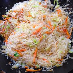 shredded carrots and cabbage cooking in a wok