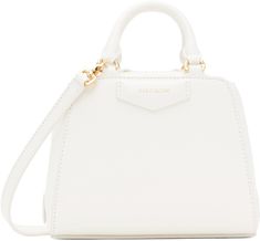 Structured and tumbled buffalo leather top handle bag in white. · Twin rolled carry handles · Adjustable and detachable crossbody strap · Logo stamp at face and back face · Two-way zip closure · Card slot at interior · Canvas lining · Logo-engraved gold-tone hardware · H5.5 x W6.5 x D3.5 Supplier color: Ivory White Bag With Gold-tone Hardware And Round Handle, White Bags With Gold-tone Hardware And Round Handle, White Satchel With Double Handle And Handle Drop, Everyday White Satchel With Round Handle, White Double Handle Satchel With Handle Drop, White Satchel With Detachable Strap And Round Handle, Formal White Shoulder Bag With Adjustable Handle, White Shoulder Bag With Round Adjustable Handle, White Shoulder Bag With Adjustable Round Handle