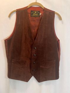 This vintage leather western vest is made in the USA. It's in great condition but does have a seam separating on pocket- see pic. size: medium  Measures: 20" pit to pit                         24" long Vintage Fitted Leather Vest, Fitted Vintage Leather Vest, Retro Fall Vest With Pockets, Vintage Leather Vest Outerwear, Vintage Brown Sleeveless Outerwear, Fitted Western Vest Outerwear, Leather Vest With Pockets For Fall, Fitted Western Style Vest Outerwear, Fitted Western Style Outerwear Vest