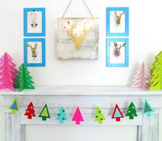 colorful christmas trees are hanging on the mantle