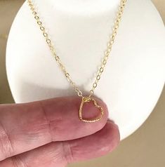 This tiny floating 14k gold filled open heart charm necklace is finished with a delicate chain and lobster claw clasp.  The necklace is available in customizable lengths from the drop down menu at check out. The heart charm is approximately 10mm.  It's wonderful on its own or layered with other necklaces.  A sweet gift for bridesmaids, mom on mother's day or a special woman on any occasion!  You may also like to  check out more of my necklaces here: http://etsy.me/2kMdyB0 Free first class USPS shipping within the USA. Minimalist 14k Gold Filled Open Heart Jewelry, Simple Gold Charm Necklace For Valentine's Day, 14k Gold Filled Charm Necklace For Valentine's Day Gift, Simple Gold Necklaces For Valentine's Day, Delicate 14k Gold Filled Heart Necklace For Valentine's Day, Delicate 14k Gold Open Heart Charm Necklace, Minimalist Open Heart Charm Necklaces For Mother's Day, Minimalist Open Heart Charm Necklace As A Gift, Gold Minimalist Open Heart Charm Necklace