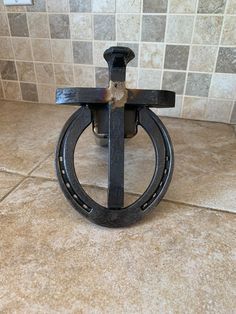 a metal object sitting on top of a tiled floor