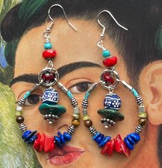 Bright and beautiful hues of blue, red, turquoise and earth colors make up these southwest inspired multi-beaded earrings. Red bamboo coral chips, blue lapis nuggets, turquoise, howlite, tiger eye, Czech glass, silver spacer beads, and African trade beads make up these  statement hoop earrings. Measuring 2.5 inches from the bottom of the earring wires. Maximalist Jewelry, Red Bamboo, Earth Colors, Bamboo Coral, Statement Hoop Earrings, Viva La Vida, African Trade Beads, Earring Wires, Red Turquoise