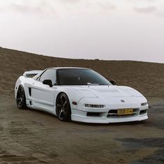 a white sports car parked in the desert