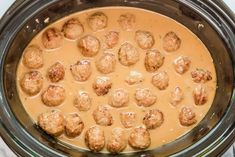 a crock pot filled with meatballs and gravy