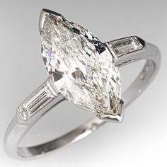 an oval cut diamond ring with baguettes on the shoulders