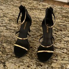 Black Stiletto Heels With Gold Accent. Never Worn. Black Gold Shoes, Black Dress With Gold Heels, Black And Gold Heels Prom, Black Heels With Gold Accent, Chic Black Heels With Gold Chain, Black And Gold High Heels, Black Heels Gold Accent, Black Gold Heels, Black And Gold Heels