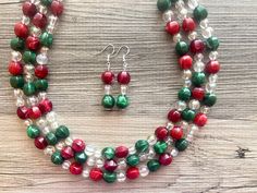 Great necklace for the holiday season! Various shades of red, green, and aurora borealis acrylic beads in our signature confetti style :) Approximately 16 inches long plus a 4 inch extender chain. *Smoke and pet free home!* I ship 6 days a week! Thank you for browsing my store! Red Christmas Jewelry With Colorful Beads, Handmade Red Beaded Necklaces For Christmas, Handmade Red Beaded Necklace For Christmas, Red Faceted Beads Jewelry For Christmas, Festive Christmas Beads With Round Shape, Christmas Festive Round Beads, Festive Christmas Beads, Handmade Red Beads For Christmas, Handmade Red Christmas Beads