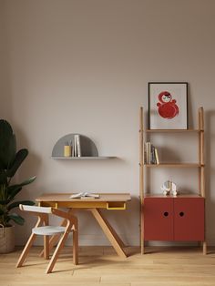 an empty room with a table and two chairs in front of a book shelf on the wall