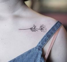 a woman with a flower tattoo on her chest