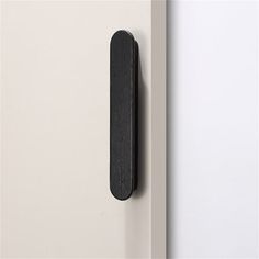 a black door handle on a white door